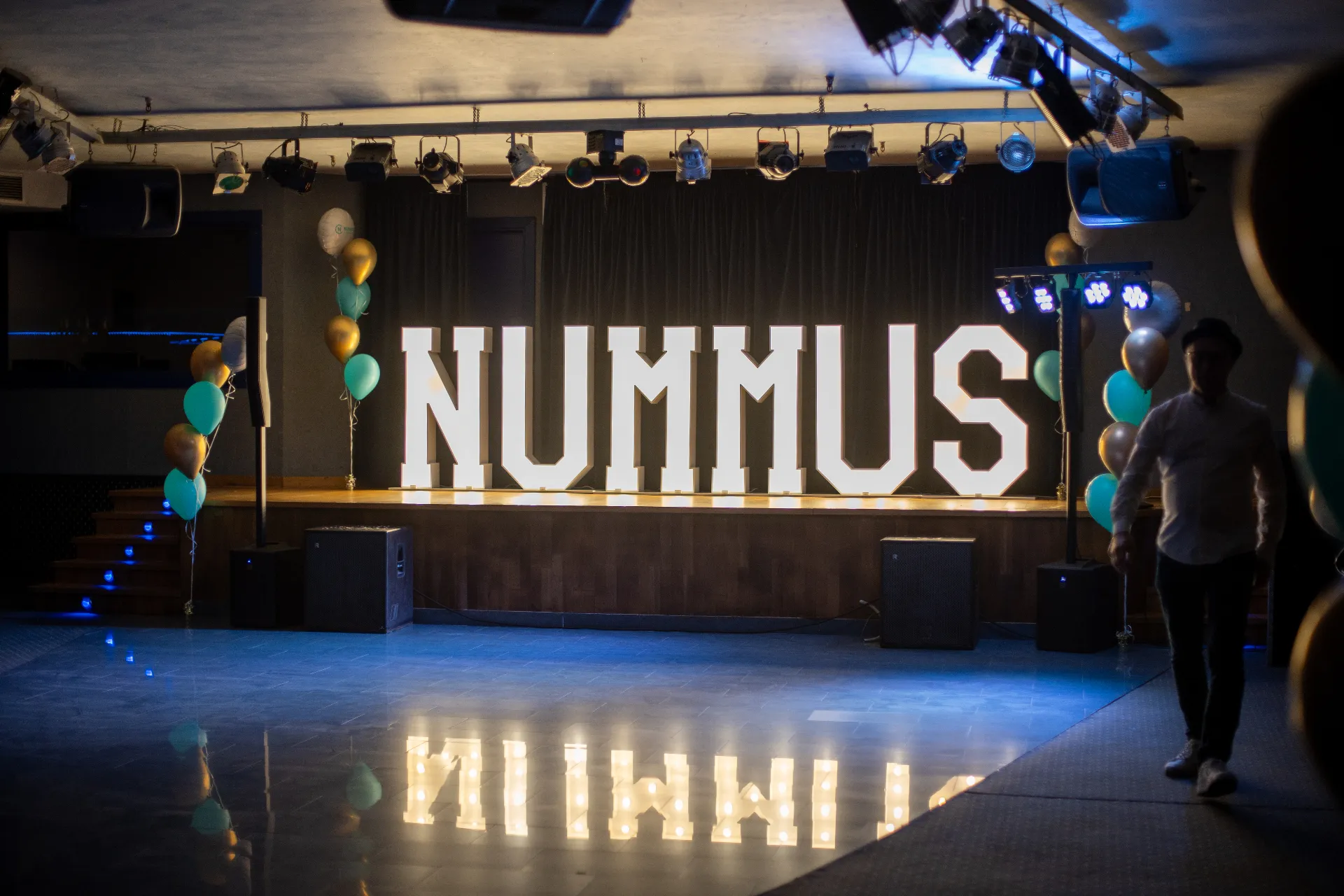 Nummus event stage lit up with the Nummus logo